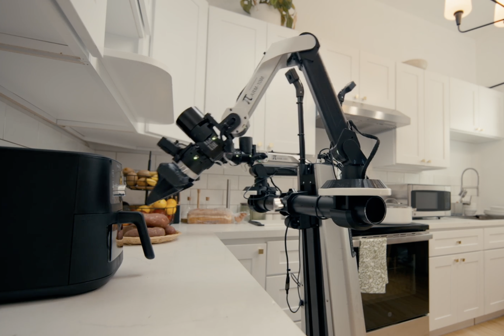 Physical Intelligence's pi-arm robot working in a kitchen
